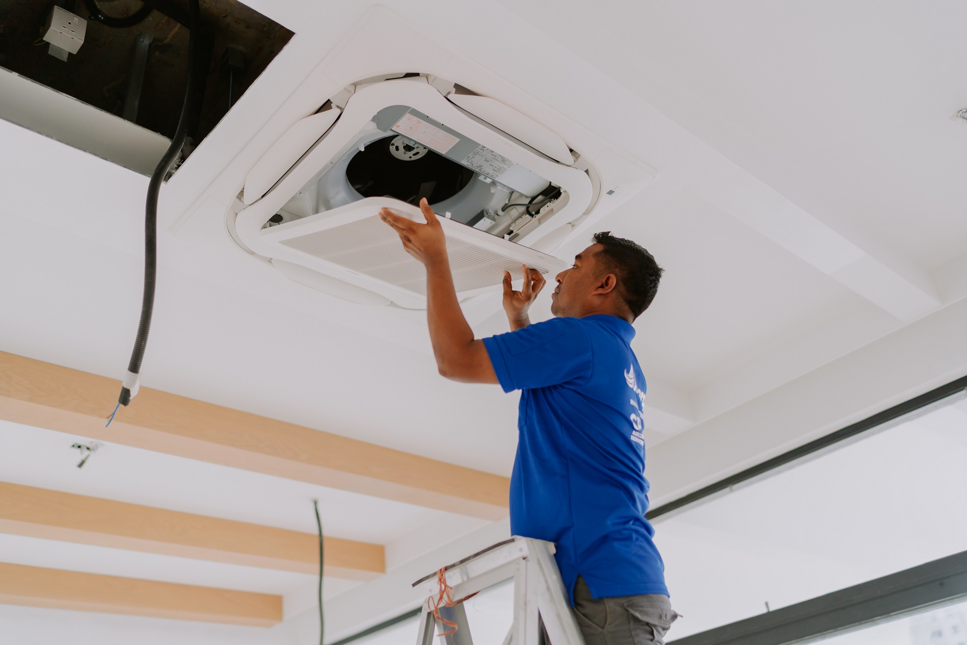 Airnergy team standing beside outdoor unit